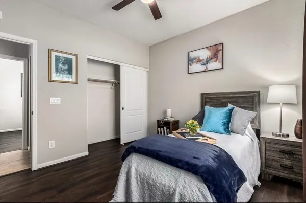 a bedroom with a bed and wooden floor