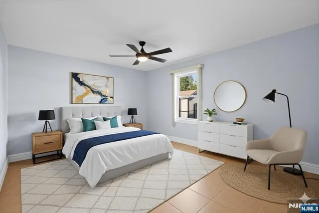 a bedroom with a large bed and a chandelier