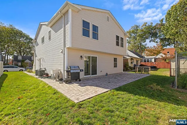 a view of a house with a yard and sitting area
