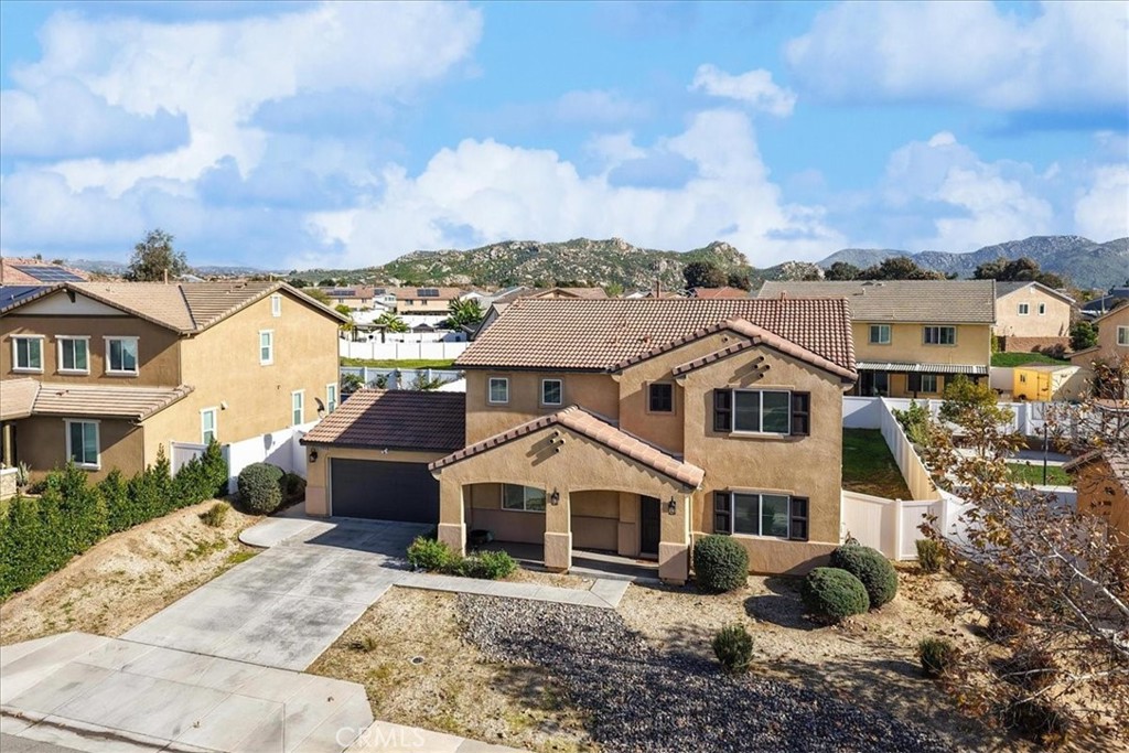 12956 Azalea Street Moreno Valley, CA 92555 - Photo 32 of 34 a view of a big house with a big yard and potted plants