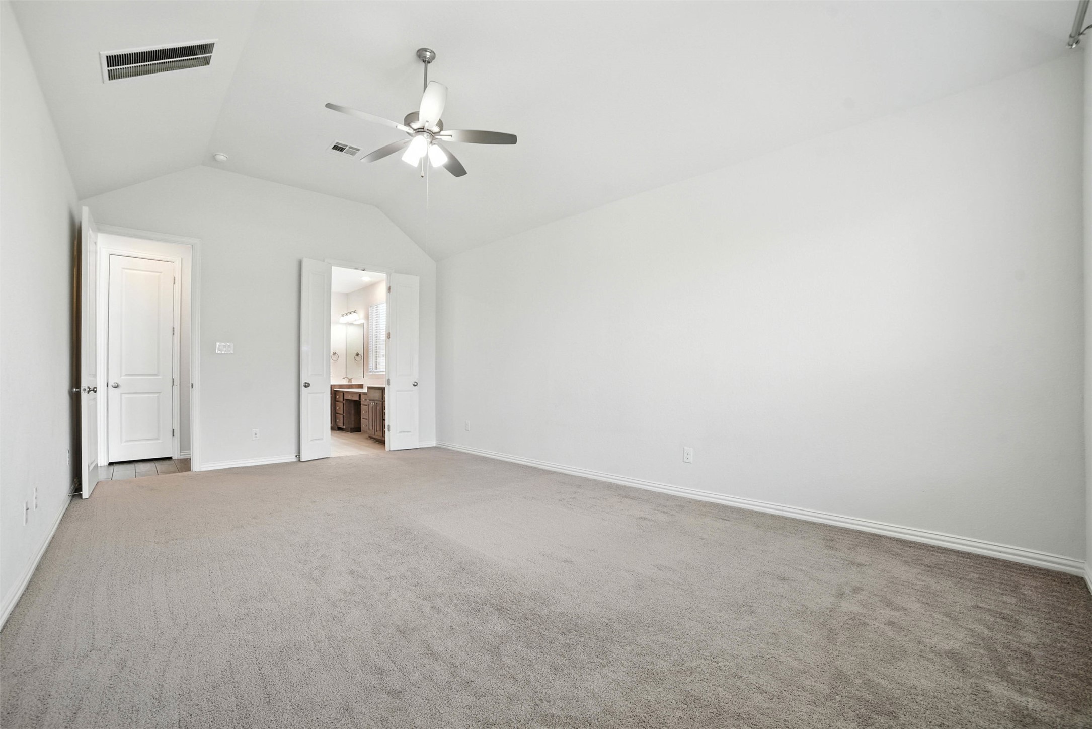 3054 Columbus Loop Round Rock, TX 78665 - Photo 17 of 40 Unfurnished bedroom with lofted ceiling, carpet, ensuite bath, and ceiling fan