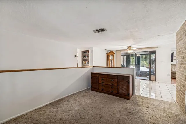 a kitchen with a refrigerator a stove and white cabinets