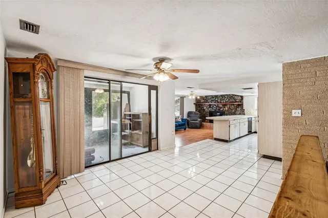 a kitchen with a sink a refrigerator and white cabinets