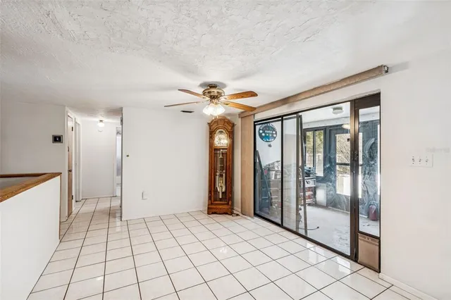 a kitchen with stainless steel appliances kitchen island a table chairs in it and wooden floors