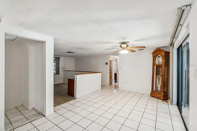 a kitchen with stainless steel appliances a sink a stove a table and chairs
