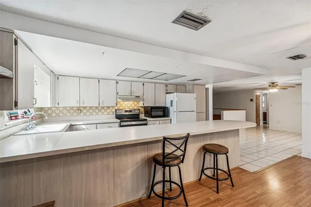 a kitchen with a stove cabinets and a sink