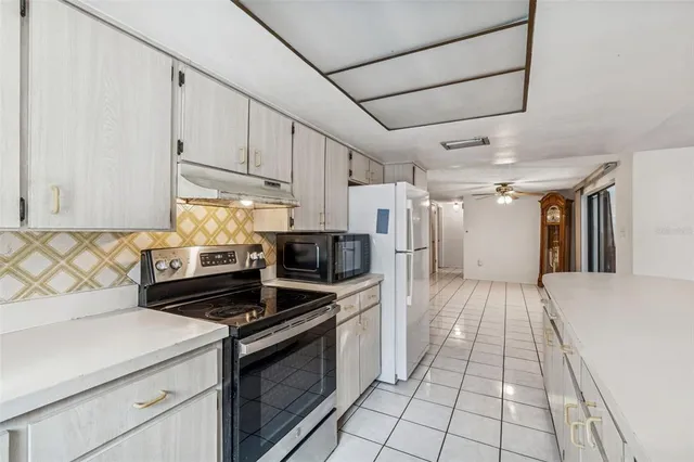 a bathroom with a granite countertop toilet sink and mirror