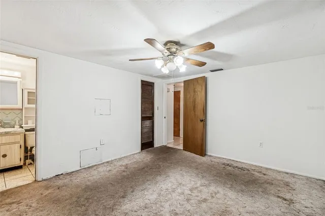 a view of an empty room with a closet