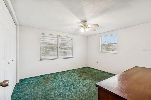 a view of a yard with trees and a house