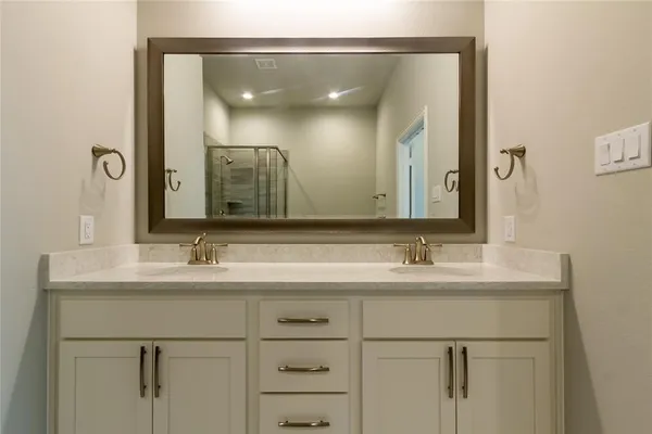 a bathroom with a double vanity sink and mirror
