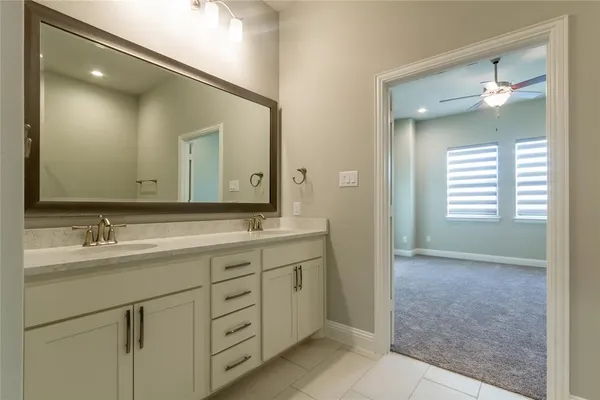 a bathroom with a double vanity sink and mirror