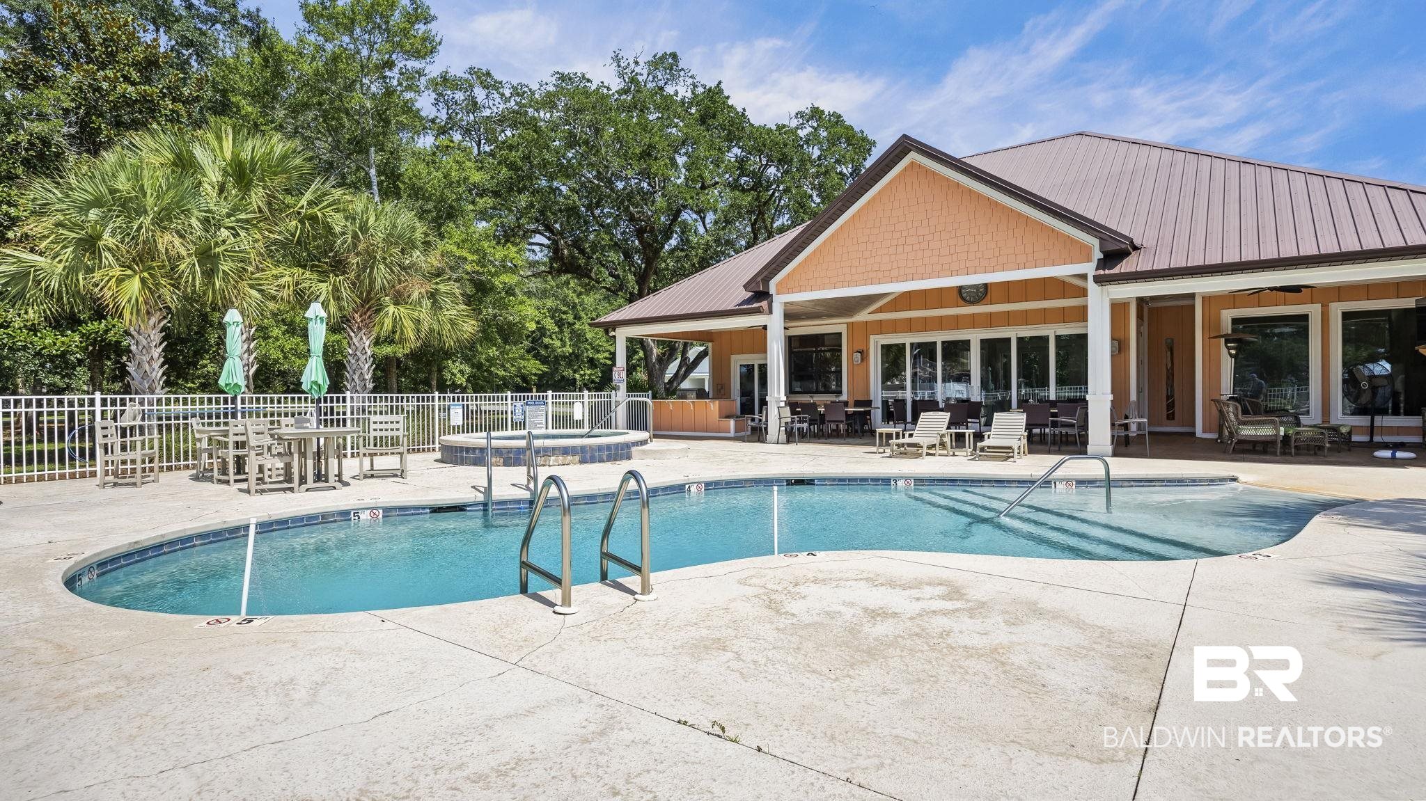 12361 Reunion Place Foley, AL 36535 - Photo 35 of 43 Community pool with a patio area and outdoor dining space