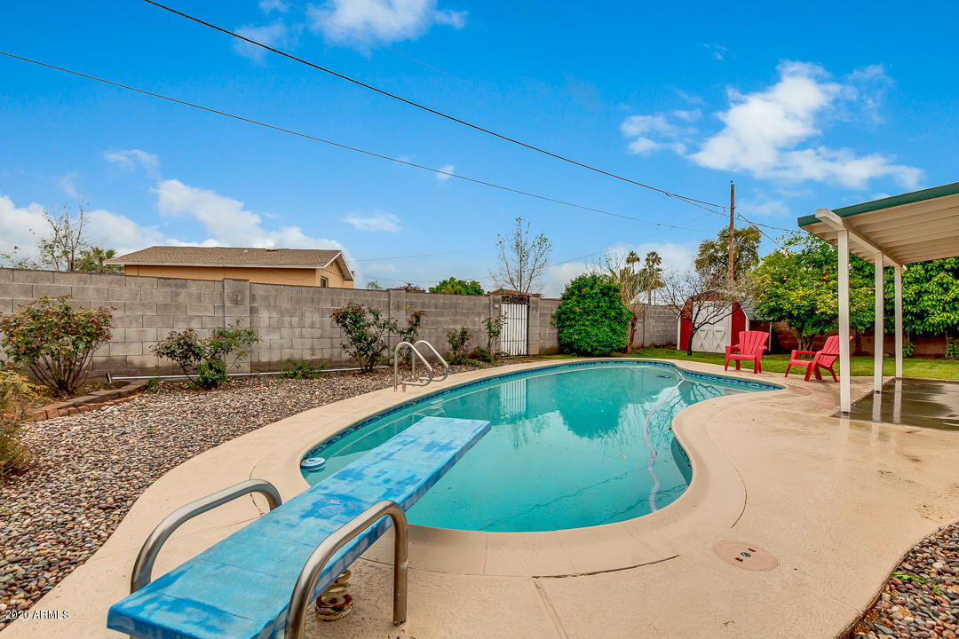 3931 West Rancho Drive Phoenix, AZ 85019 - Photo 31 of 32 a view of a swimming pool with a patio