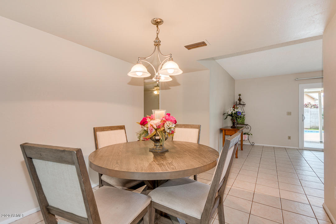 3931 West Rancho Drive Phoenix, AZ 85019 - Photo 6 of 32 a dining room with furniture and chandelier