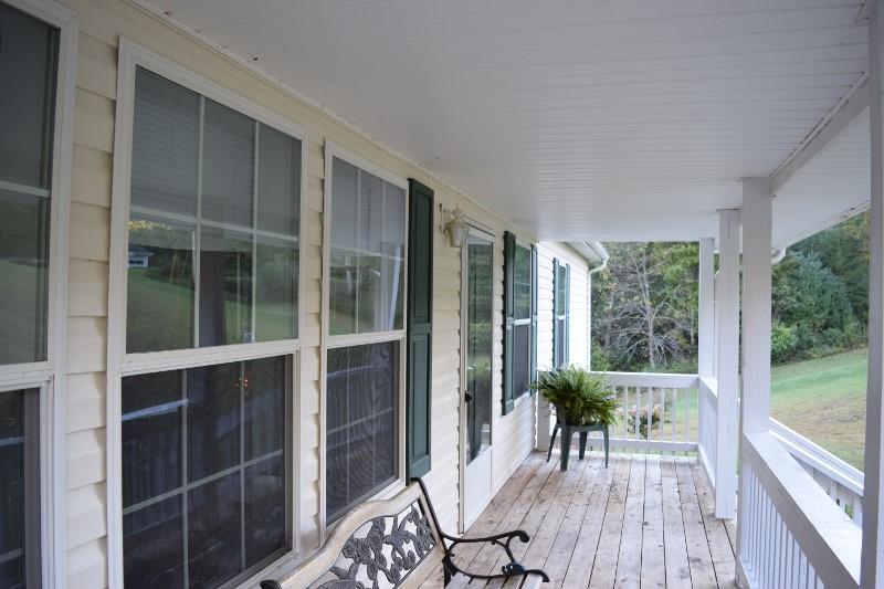 440 Horse Ridge Road Northwest Willis, VA 24380 - Photo 13 of 62 a view of a house with a porch and furniture