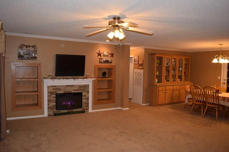 440 Horse Ridge Road Northwest Willis, VA 24380 - Photo 36 of 62 a living room with furniture a flat screen tv and a fireplace