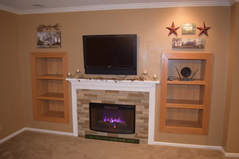 440 Horse Ridge Road Northwest Willis, VA 24380 - Photo 38 of 62 a living room with a fireplace and a flat screen tv