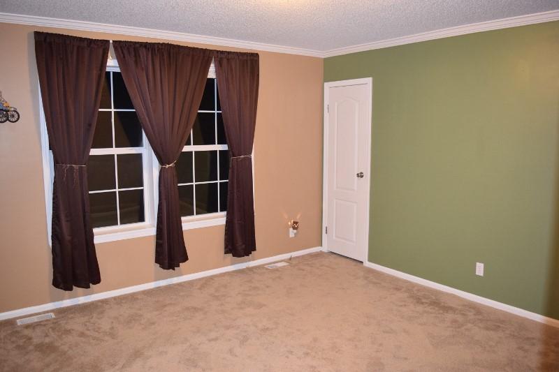 440 Horse Ridge Road Northwest Willis, VA 24380 - Photo 42 of 62 an empty room with wooden floor and windows