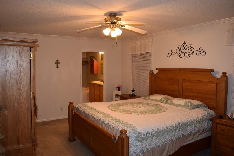 440 Horse Ridge Road Northwest Willis, VA 24380 - Photo 48 of 62 a bedroom with a bed and a chandelier