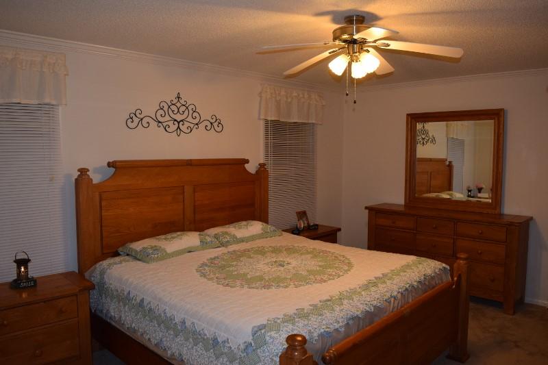 440 Horse Ridge Road Northwest Willis, VA 24380 - Photo 49 of 62 a bedroom with a bed and a chandelier
