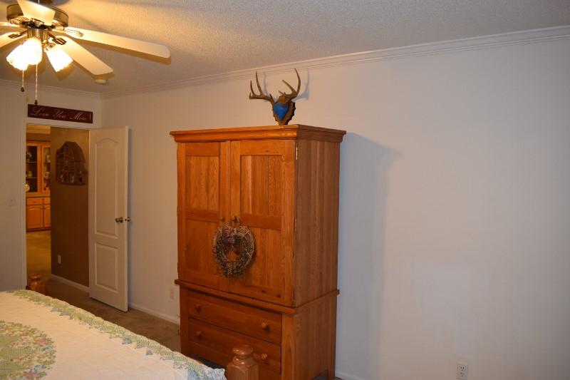 440 Horse Ridge Road Northwest Willis, VA 24380 - Photo 50 of 62 a bedroom with a bed and a chandelier fan