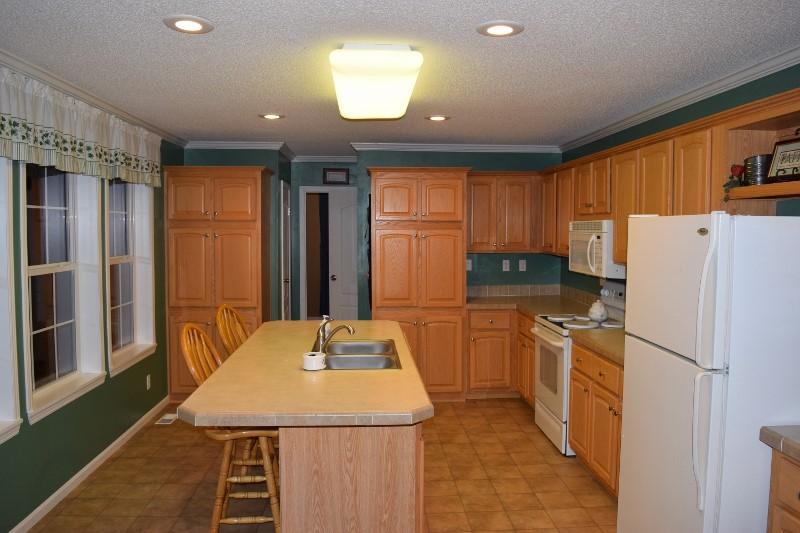 440 Horse Ridge Road Northwest Willis, VA 24380 - Photo 57 of 62 a kitchen with stainless steel appliances granite countertop a refrigerator sink stove and large window