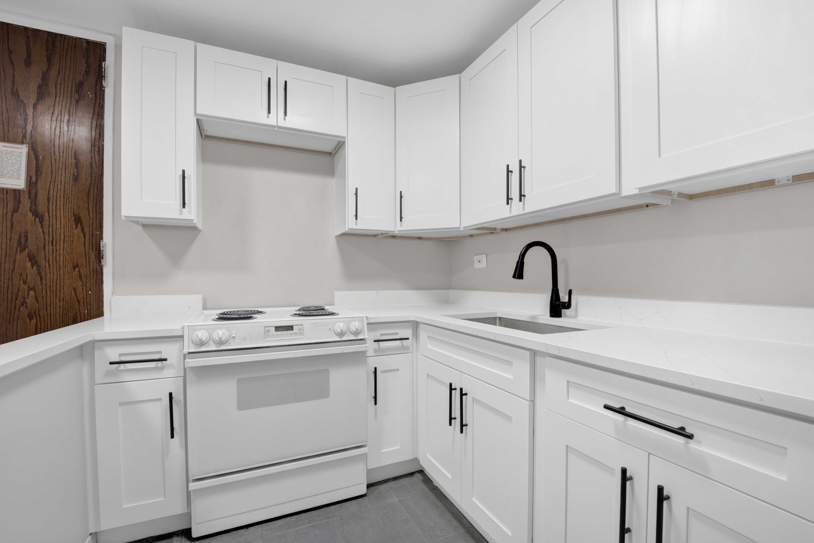 720 West Gordon Terrace, Unit 7F Chicago, IL 60613 - Photo 8 of 15 a kitchen with white cabinets and white appliances