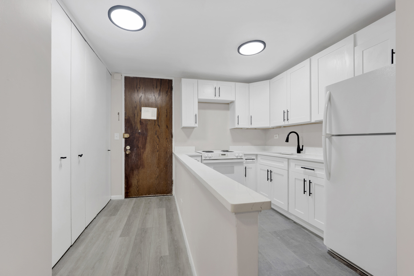 720 West Gordon Terrace, Unit 7F Chicago, IL 60613 - Photo 9 of 15 a kitchen with white cabinets and white appliances