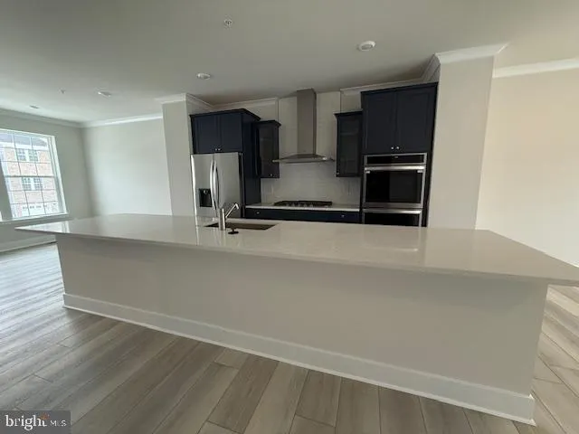 a kitchen with stainless steel appliances a sink and a refrigerator
