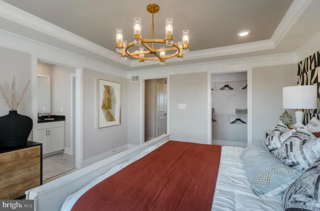 a bedroom with a bed and chandelier