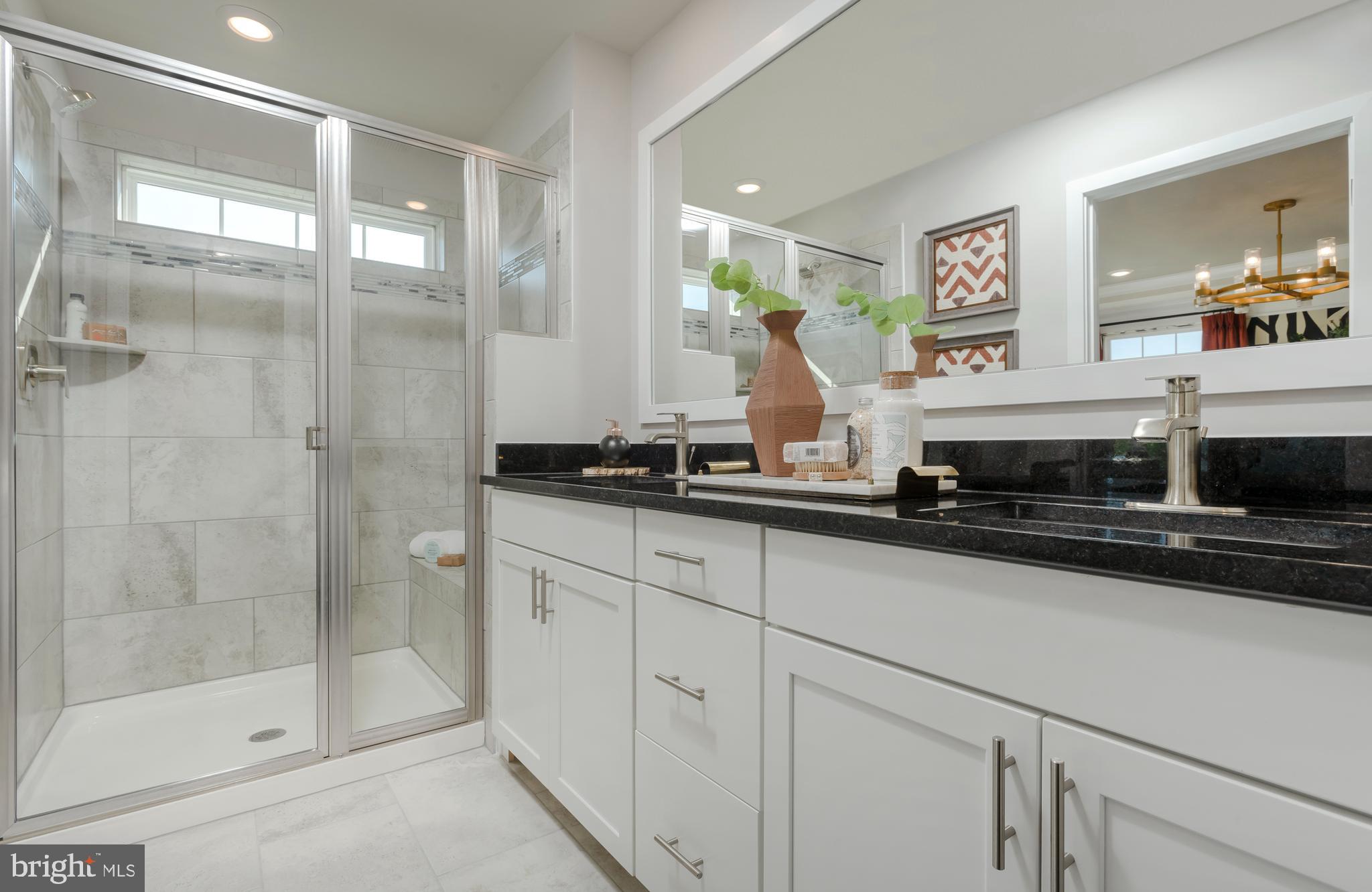 1806 Oxbow Road Baltimore, MD 21244 - Photo 7 of 10 a bathroom with a double vanity sink and a mirror