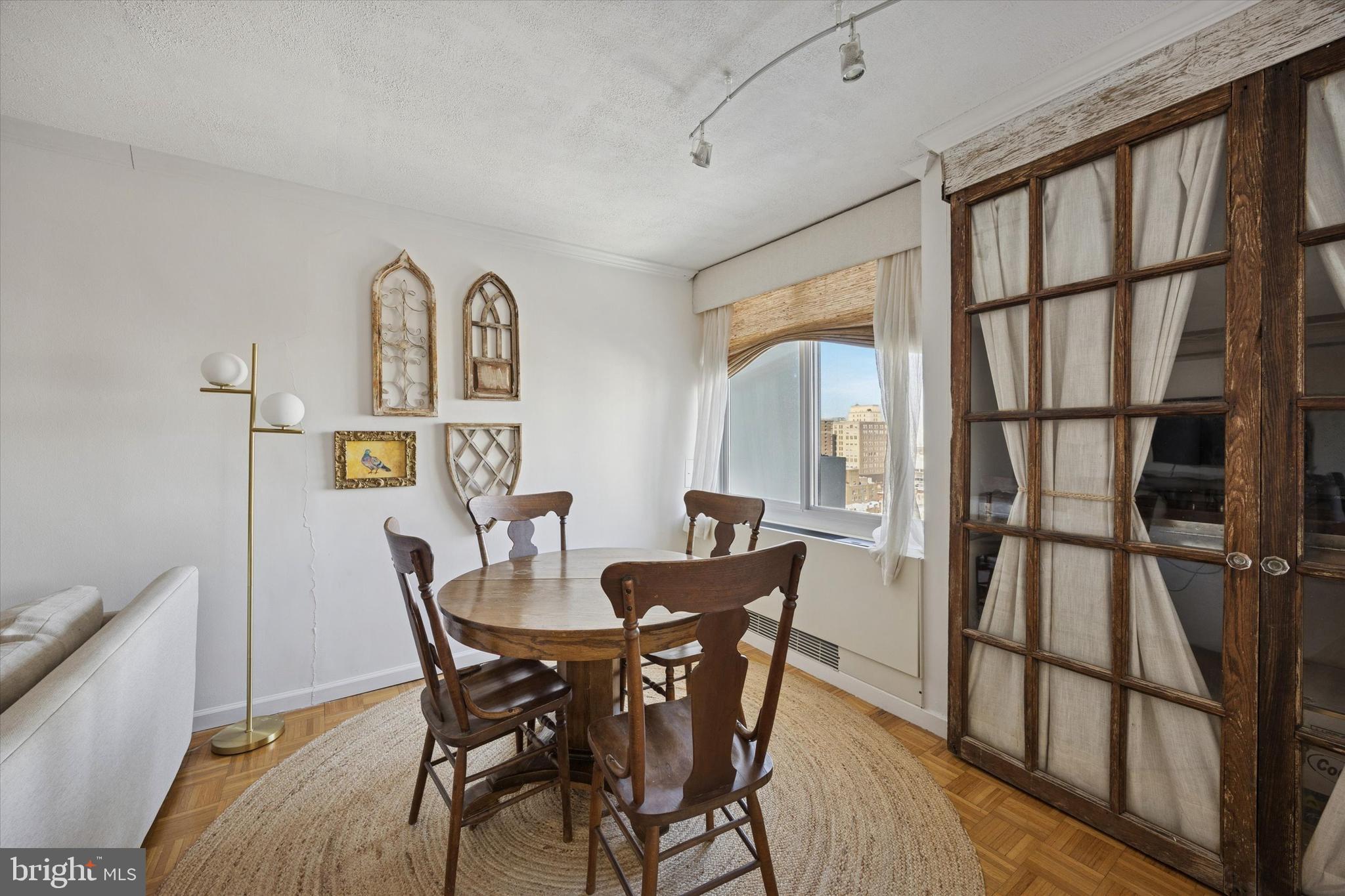 604 South Washington Square, Unit 1806 Philadelphia, PA 19106 - Photo 11 of 23 a view of a dining room with furniture window and wooden floor