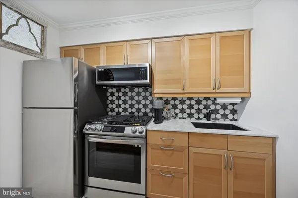 a kitchen with granite countertop cabinets and steel stainless steel appliances