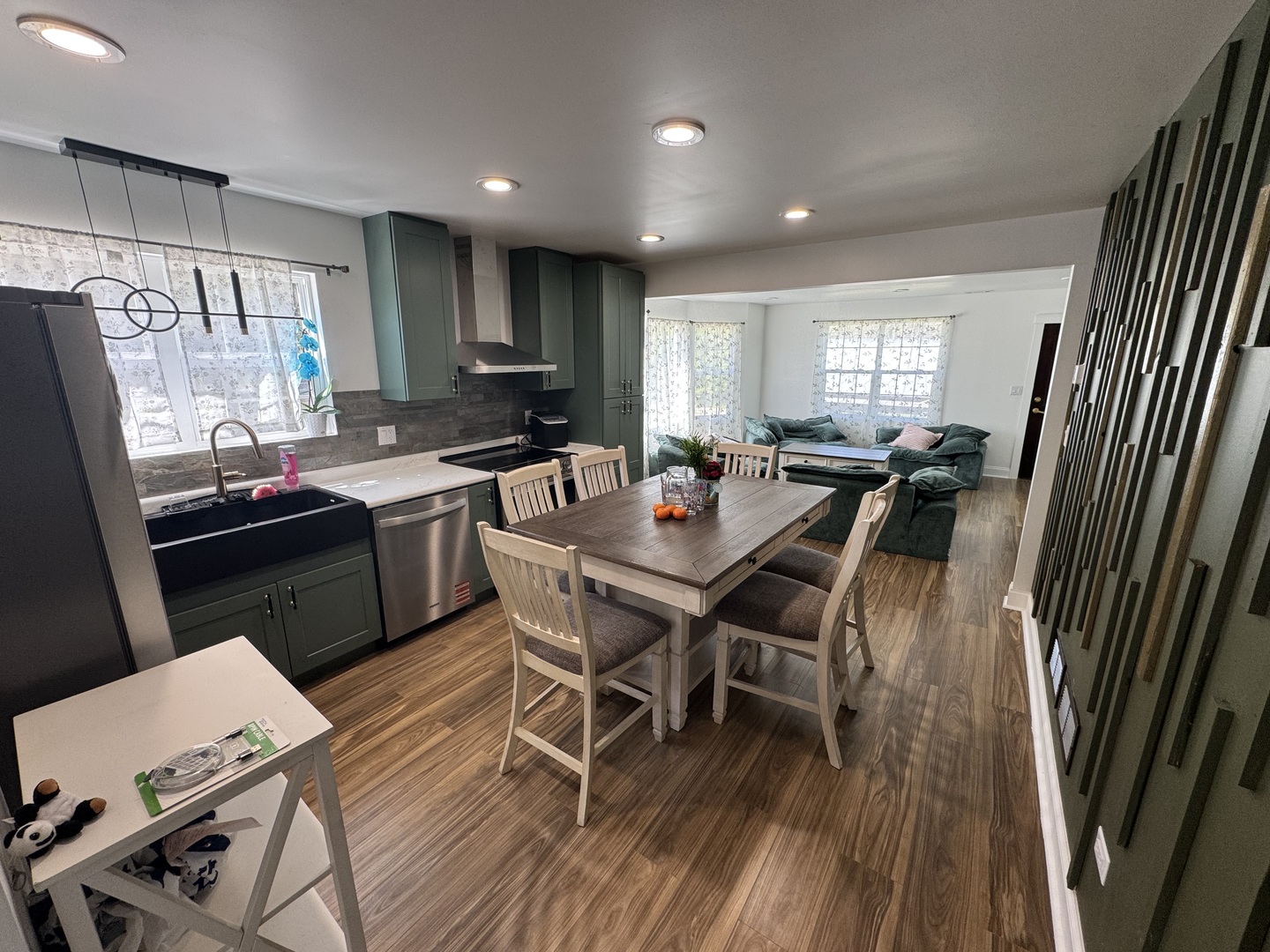 931 South Rawson Bridge Road Cary, IL 60013 - Photo 6 of 36 a kitchen with a dining table chairs sink refrigerator and microwave