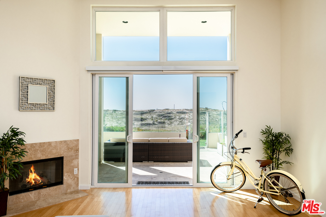 7301 Vista Del Mar, Unit 40 Playa del Rey, CA 90293 - Photo 5 of 29 a view of a livingroom with a patio a fireplace and wooden floor