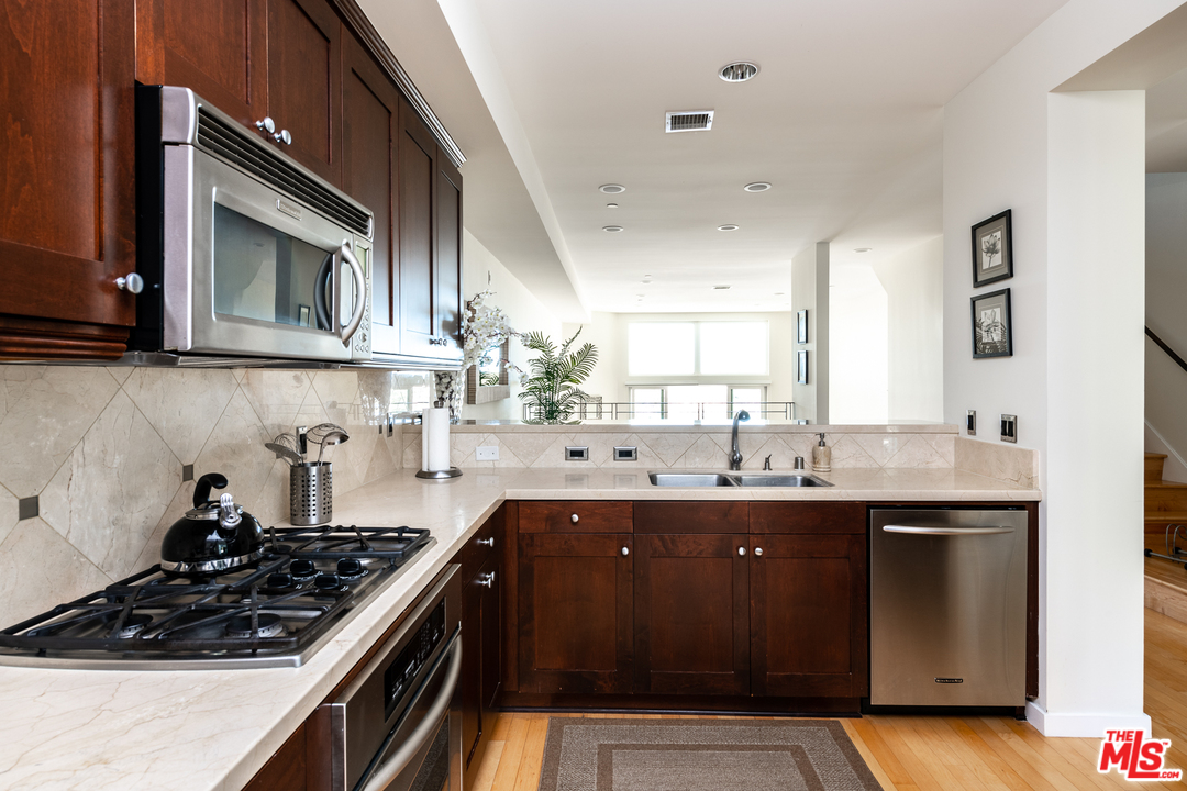 7301 Vista Del Mar, Unit 40 Playa del Rey, CA 90293 - Photo 10 of 29 a kitchen with a sink stove top oven and cabinets