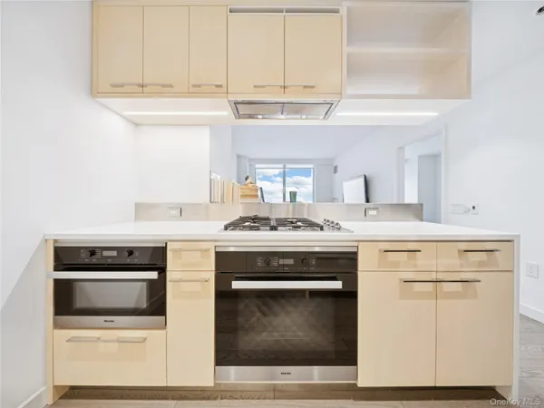 a kitchen with stainless steel appliances granite countertop a stove and a microwave