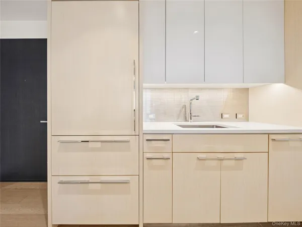 a bathroom with a sink and cabinets