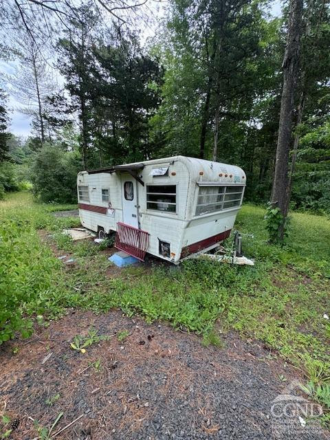 597 Vosenkill Road Catskill, NY 12414 - Photo 16 of 17 a view of a small yard with large trees and a small yard