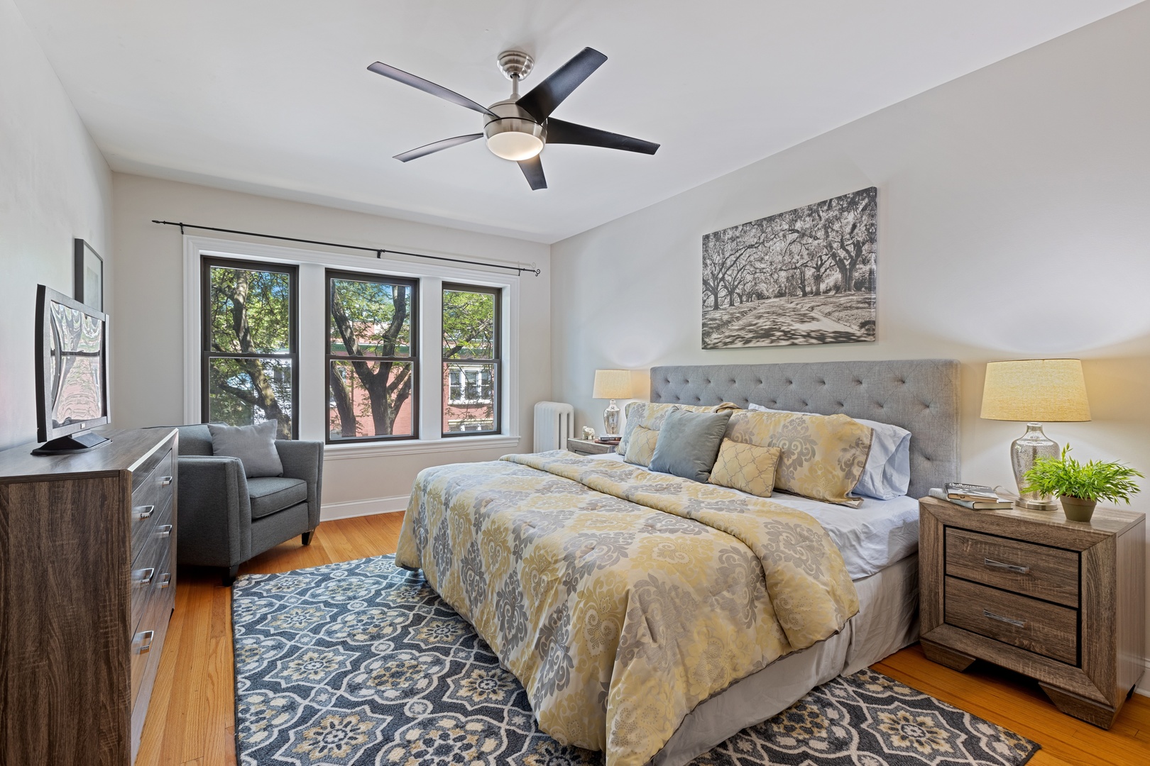 1905 West Winona Street, Unit 2 Chicago, IL 60640 - Photo 12 of 18 a bed room with a bed a couch and a window