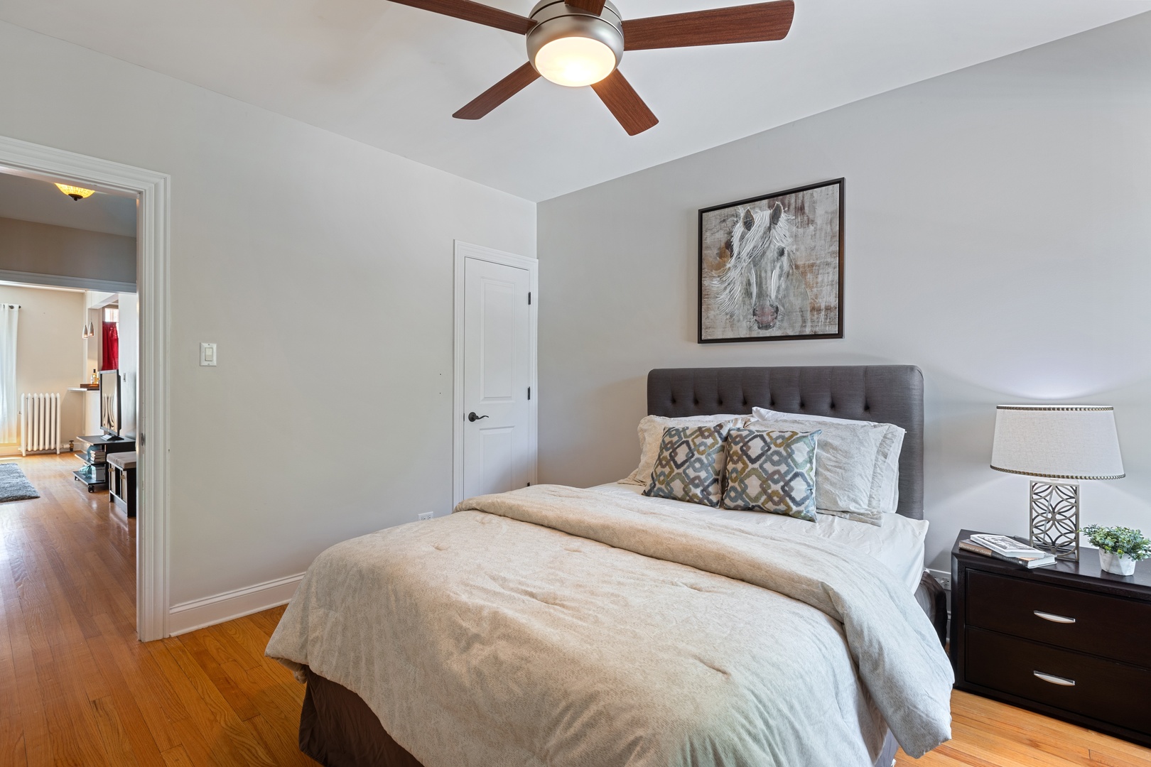 1905 West Winona Street, Unit 2 Chicago, IL 60640 - Photo 15 of 18 a bedroom with a bed and wooden floor