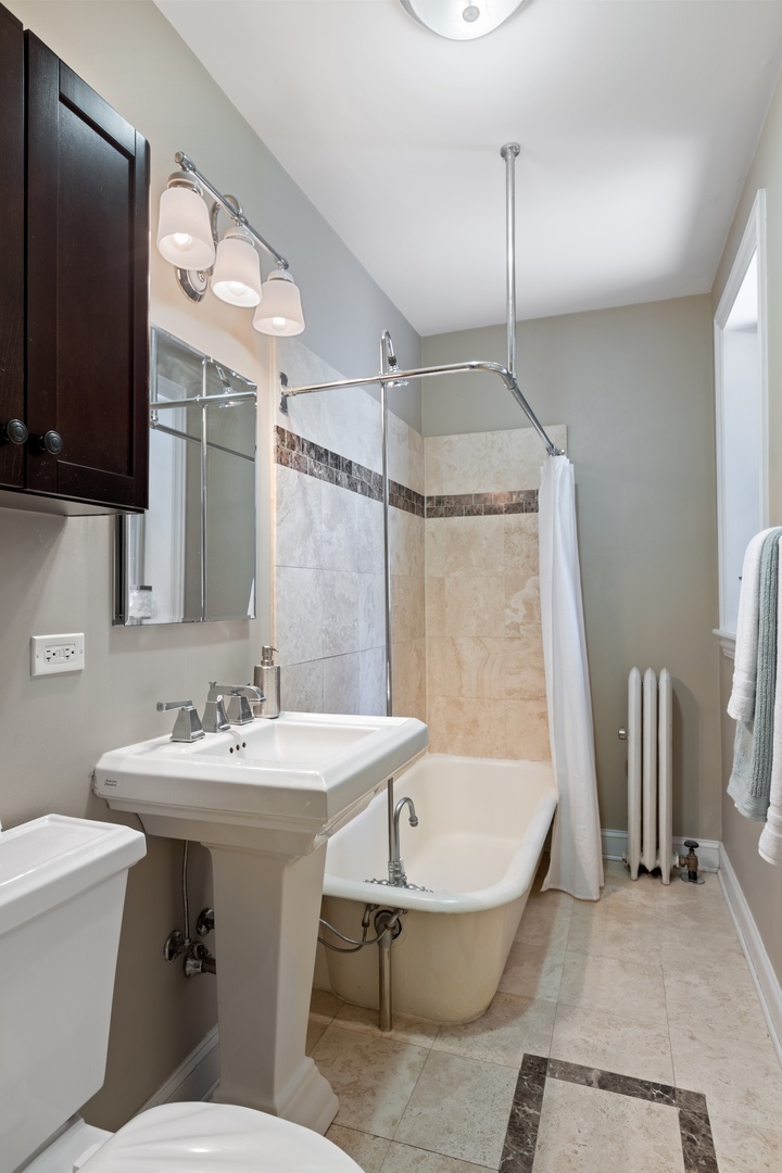 1905 West Winona Street, Unit 2 Chicago, IL 60640 - Photo 16 of 18 a bathroom with a sink toilet and shower
