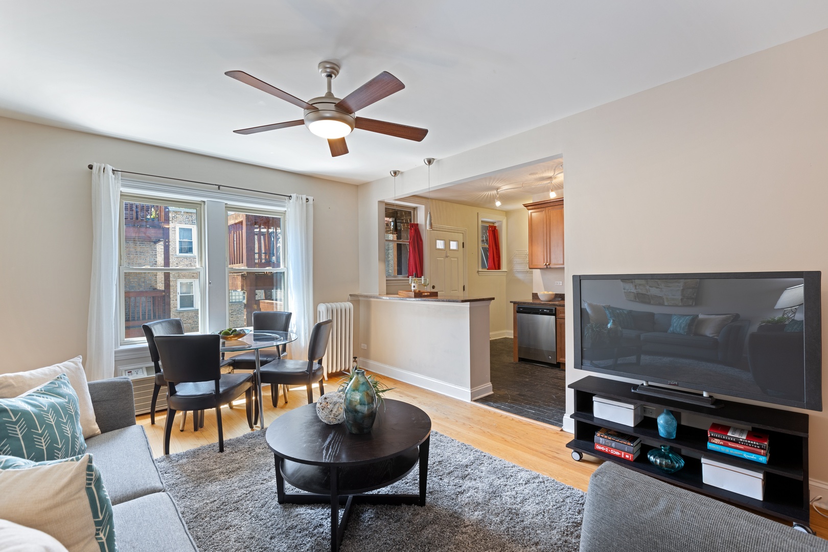 1905 West Winona Street, Unit 2 Chicago, IL 60640 - Photo 7 of 18 a living room with furniture and a flat screen tv