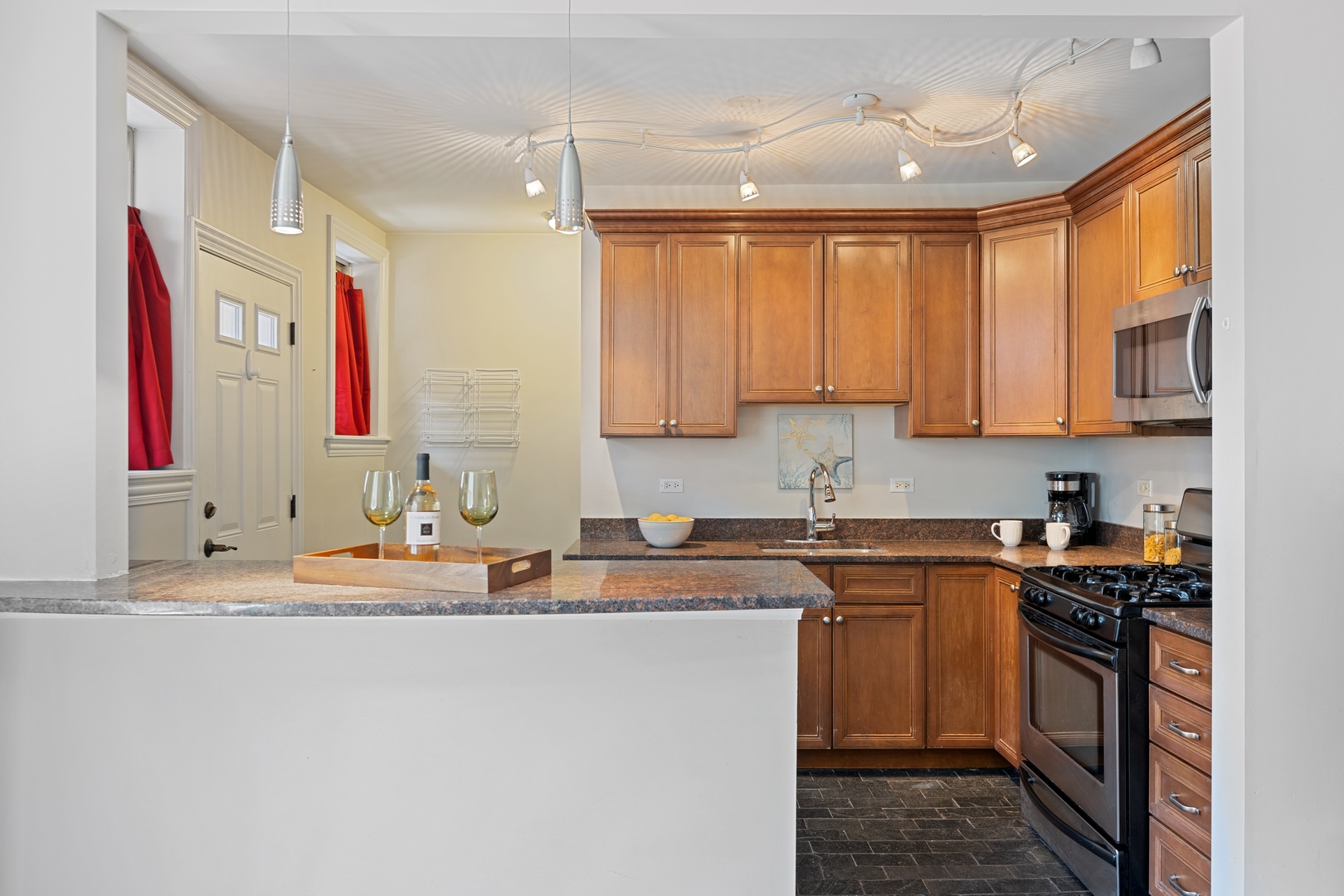 1905 West Winona Street, Unit 2 Chicago, IL 60640 - Photo 8 of 18 a kitchen with stainless steel appliances granite countertop a sink stove and cabinets