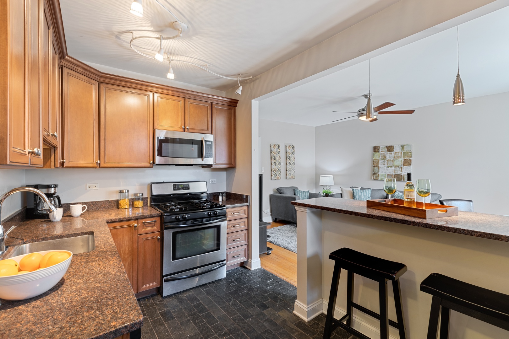 1905 West Winona Street, Unit 2 Chicago, IL 60640 - Photo 10 of 18 a kitchen with a stove a sink and a microwave