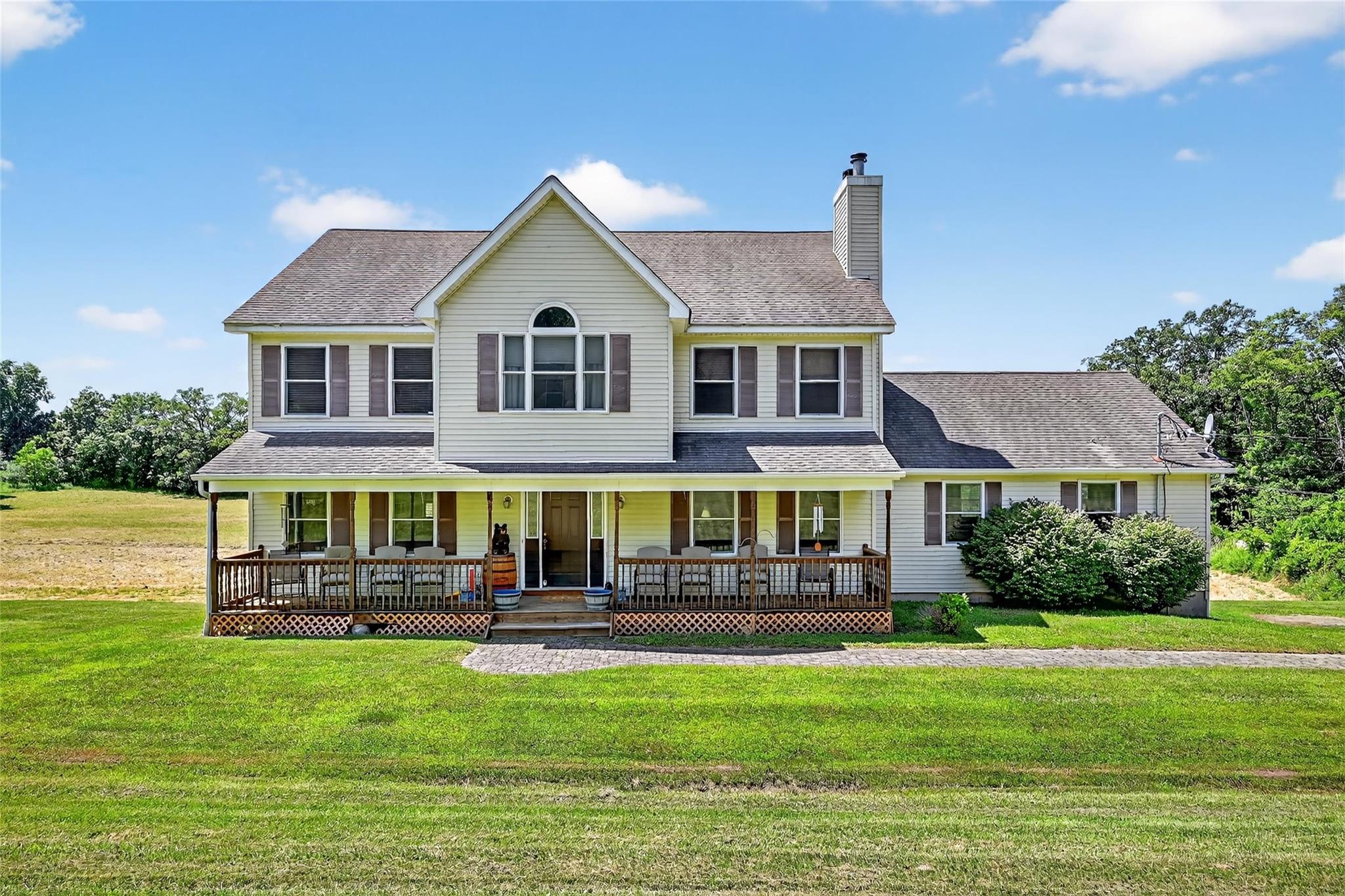 a front view of house with yard and outdoor seating