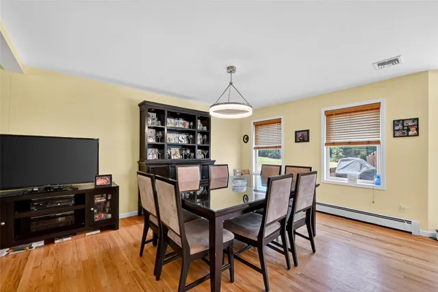 a dining room with furniture and wooden floor