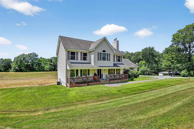 a front view of a house with a yard table and chairs