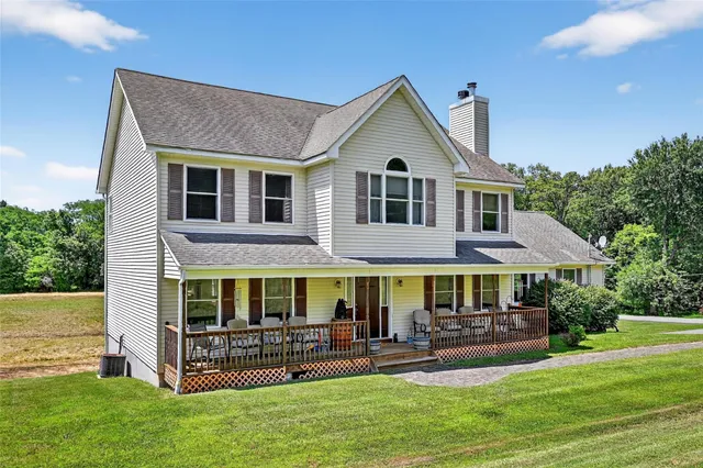 a front view of a house with a yard table and chairs