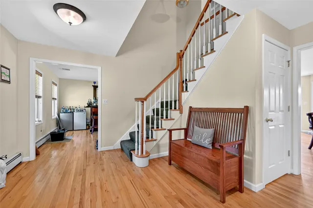 a view of entryway and hall with wooden floor